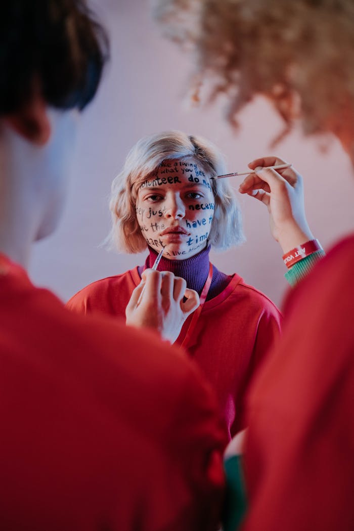 People Writing on a Woman's Face